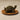 Bronze tortoise tea pet on a woven basket tray, a decorative accessory for loose leaf tea enthusiasts