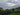 Mountain landscape with mixed trees and clouds where sustainable tea is grown 